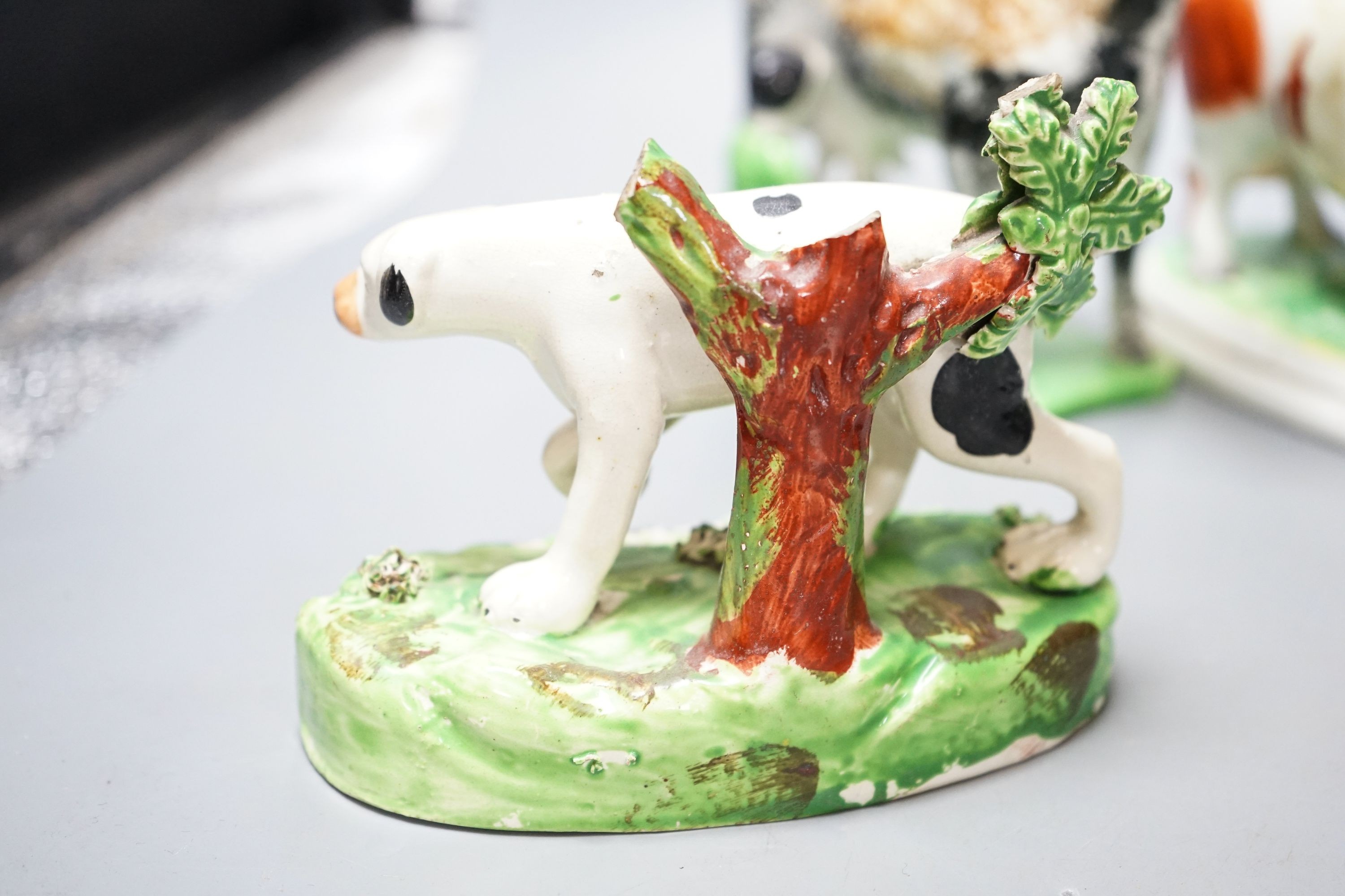 A 19th century 'Milkmaid and cow' creamer with sponged decoration, three other Staffordshire items and a Continental majolica figure of a turkey (5)